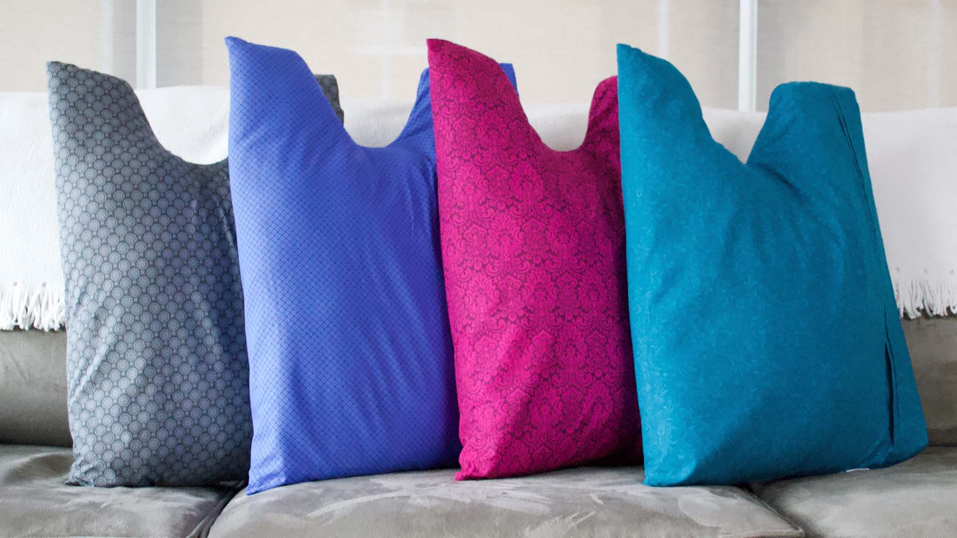 Surgery recovery pillows in gray, blue, pink and teal
