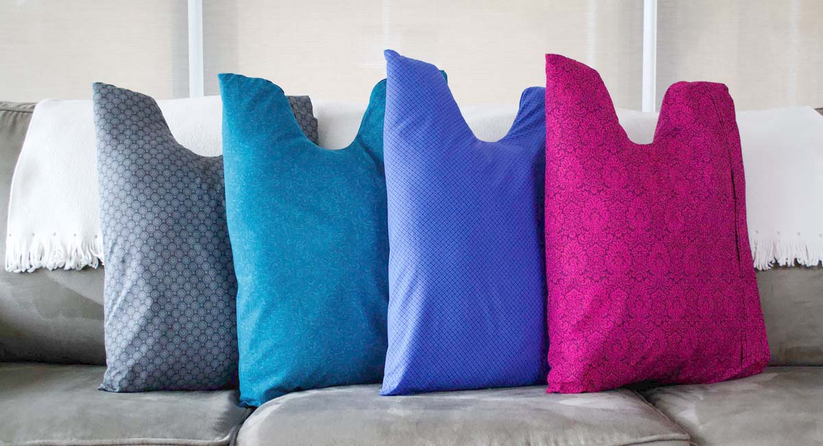 The Shell Pillow in gray, teal, blue and pink